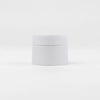 A white jar of refillable travel face cream with a leak-proof lid.