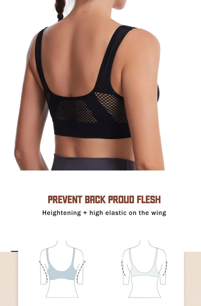 A woman wearing a black sports bra with mesh back and elastic on the wing, designed to prevent back flush.