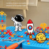 A set of colorful plastic pieces and a white astronaut figure are displayed on a blue mat, demonstrating expandable three-dim