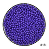 A circular arrangement of purple water beads in a black bowl.