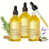 Three glass bottles of EELHOE Rosemary Hair Growth Oil with dropper applicators and surrounding greenery