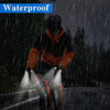 A person wearing waterproof outdoor gear and LED fingerless gloves with built-in flashlights in the rain.