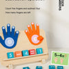 A wooden finger counting toy demonstrating a subtraction operation where five fingers are counted and four are subtracted.
