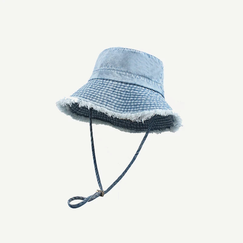 A light blue denim bucket hat with a wide brim and frayed trim.