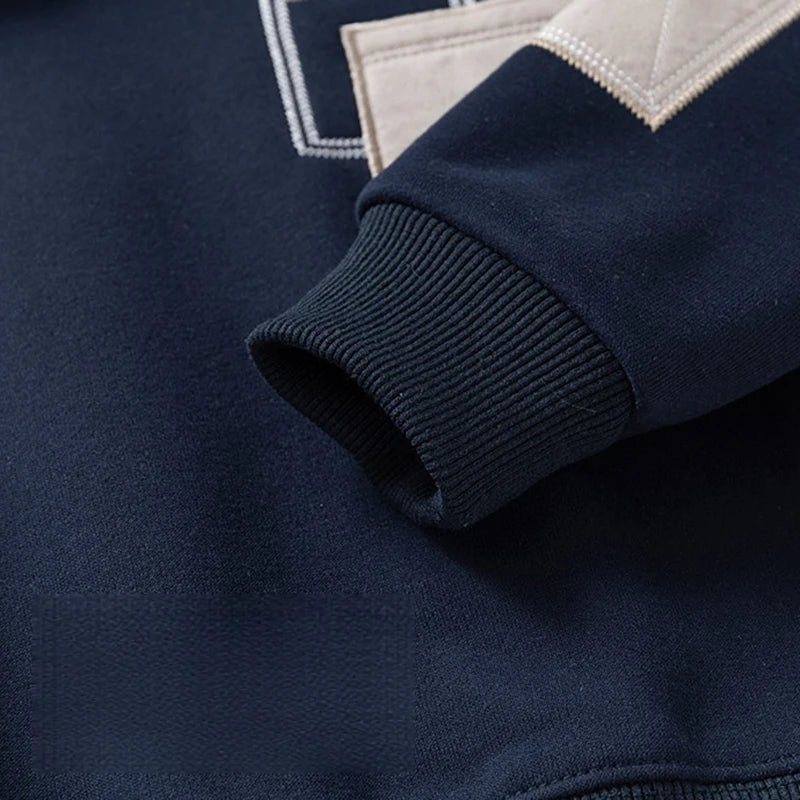 Navy fleece pullover sweatshirt with a denim collar detail and light beige cuff.