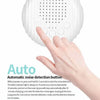 A hand is interacting with a white noise device, demonstrating its features for studying and baby care.