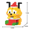 A yellow and red building block figurine of a dog wearing a Santa hat.