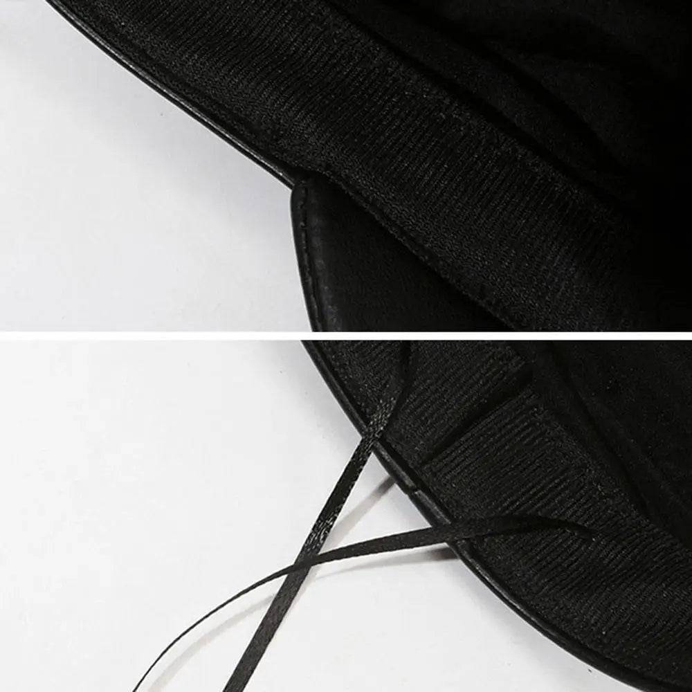 Close-up view of a black PU leather beret hat with adjustable black laces.