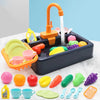 A kids pretend play kitchen sink set featuring an orange faucet, water, and various colorful plastic food items in a dark blu
