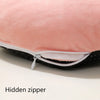 Close-up of a pink fleece cover for a USB heated foot warmer showing a hidden zipper detail.