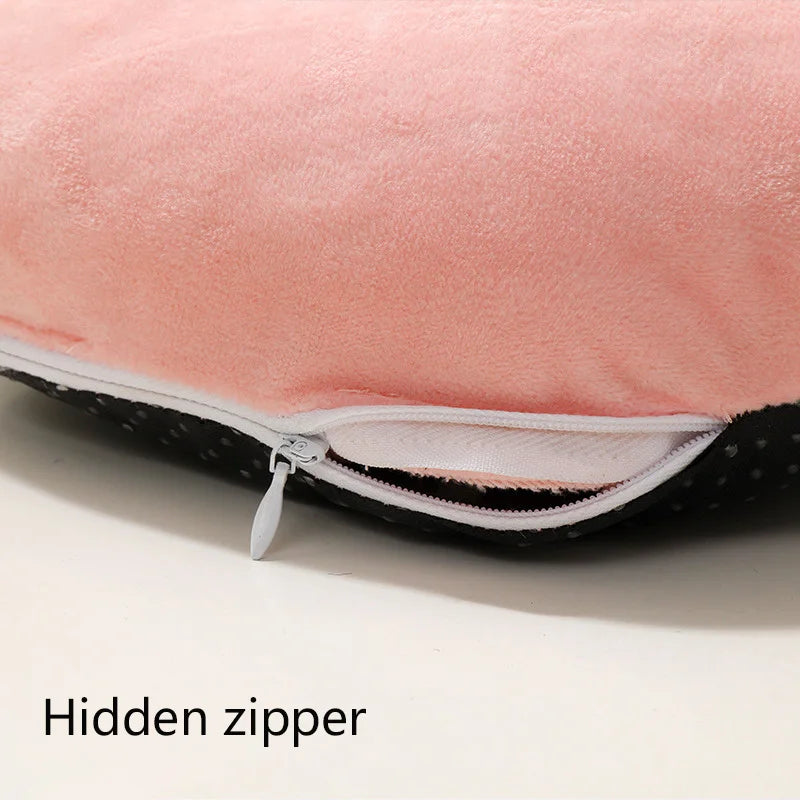 Close-up of a pink fleece cover for a USB heated foot warmer showing a hidden zipper detail.