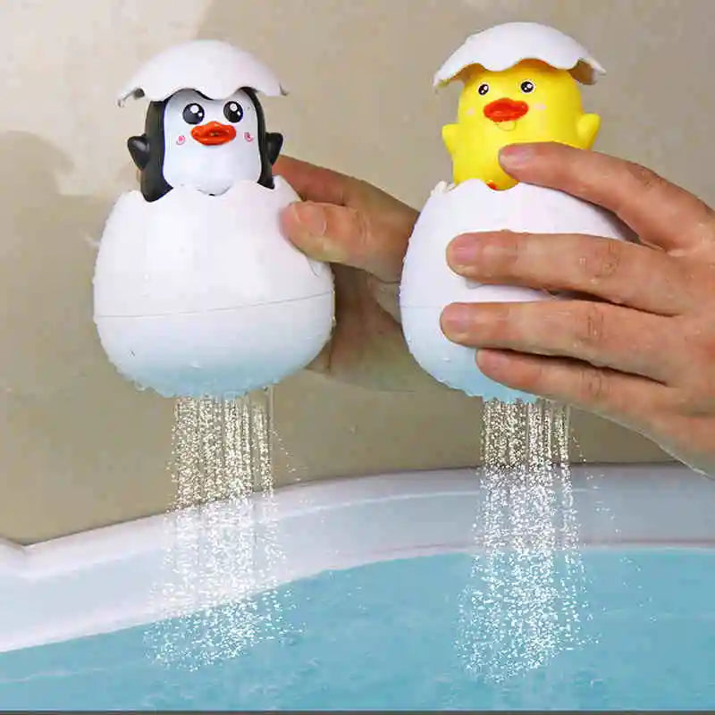 A hand is holding a white bath toy shaped like a duck, which is spraying water into a bathtub.