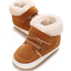 A pair of brown suede baby winter snow boots with fluffy cream-colored faux fur trim.