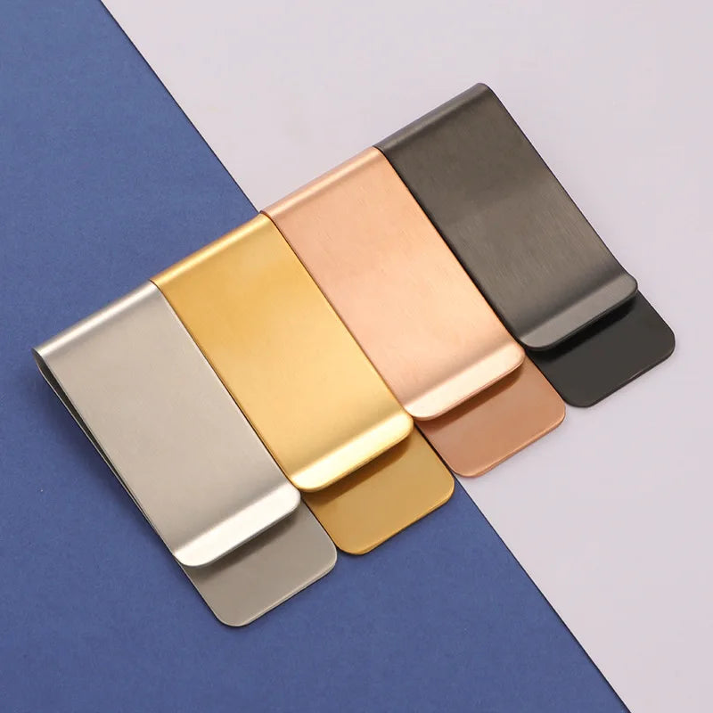 A set of five classic metal tie clips in various finishes including gold, rose gold, silver, and matte black.