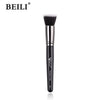 A black professional makeup brush for applying foundation, concealer, and blush.