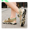 A close-up of a pair of tan and green breathable summer sport sandals worn on a person's foot.
