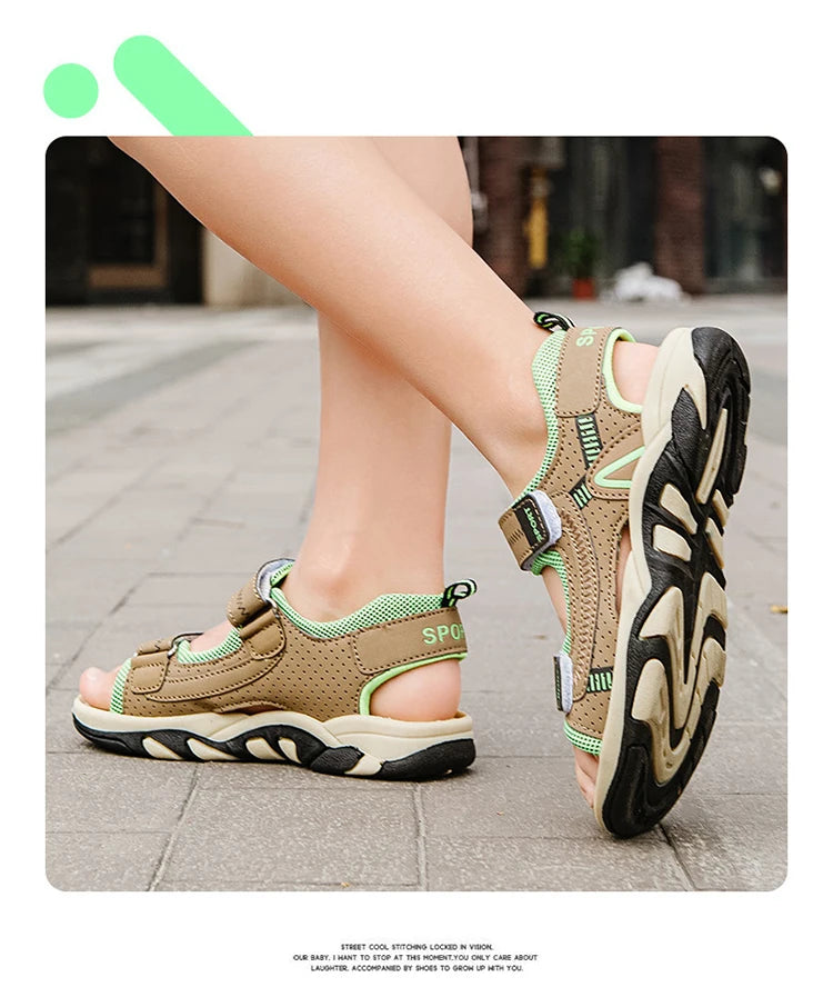 A close-up of a pair of tan and green breathable summer sport sandals worn on a person's foot.