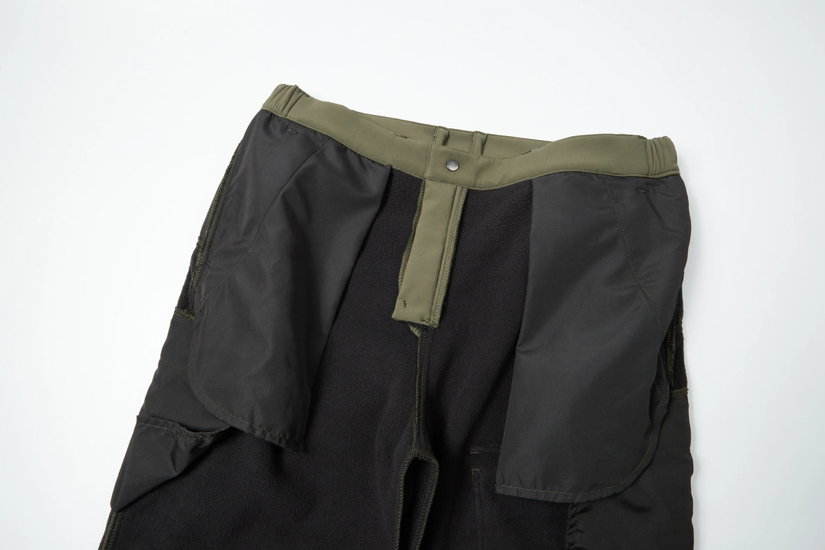 Black waterproof insulated fleece pants with olive green waistband and zipper detail.