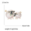 A pair of cute sheep enamel brooches with gold-toned findings and pink and black detailing.
