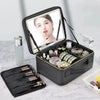A black LED lighted makeup bag with a mirror and organizer is shown open, displaying various cosmetic tools.