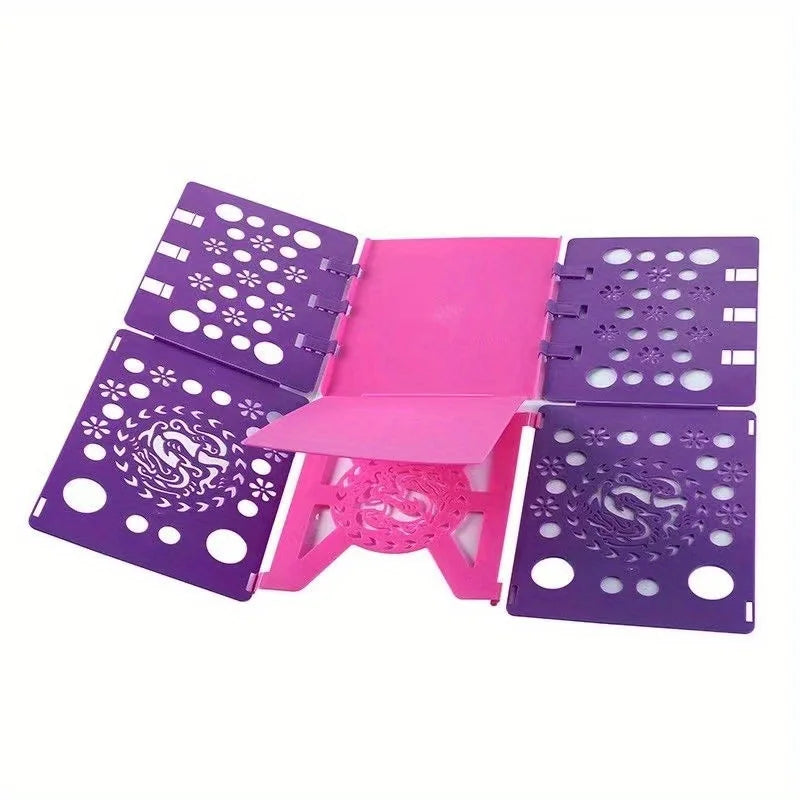 A pink and purple clothes folding board with multiple perforated sections for quick laundry folding.