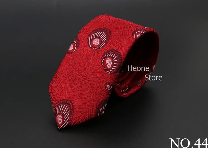Corbata jacquard roja con patrón circular repetido, doblada sobre fondo oscuro.