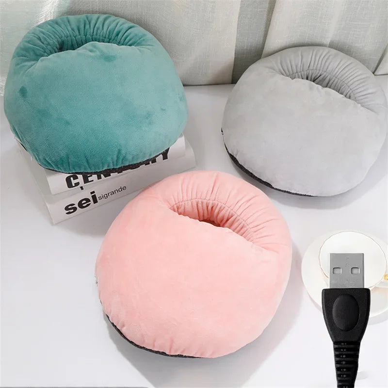Three soft fleece foot warmers in teal, gray, and pink are displayed on a white surface.
