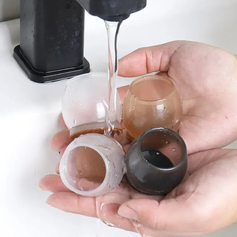 A hand is pouring liquid onto silicone furniture leg pads with felt bottoms for scratch protection.
