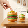 A hand presses a hamburger-shaped fidget ball, demonstrating press once, spin instantly, and fidget fun features.