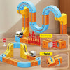 A set of magnetic train building blocks featuring a gravity maze structure in orange, yellow, and blue.