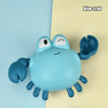 A blue crab bath toy featuring a cute, rounded body and claws against a light yellow background.