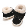 A pair of black baby winter snow boots with fluffy cream-colored faux fur trim.