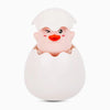 A white bath toy shaped like a duck or penguin with a smiling face emerging from an egg-like base.