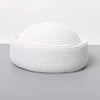 A white straw pillbox sun hat with a wide brim shown against a gray background.