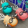 Three colorful interactive jellyfish toys with lights and music are displayed on a gray surface.