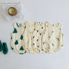 A set of five cream-colored baby cotton sleeveless jumpsuits or bodysuits with subtle green and black leaf patterns.