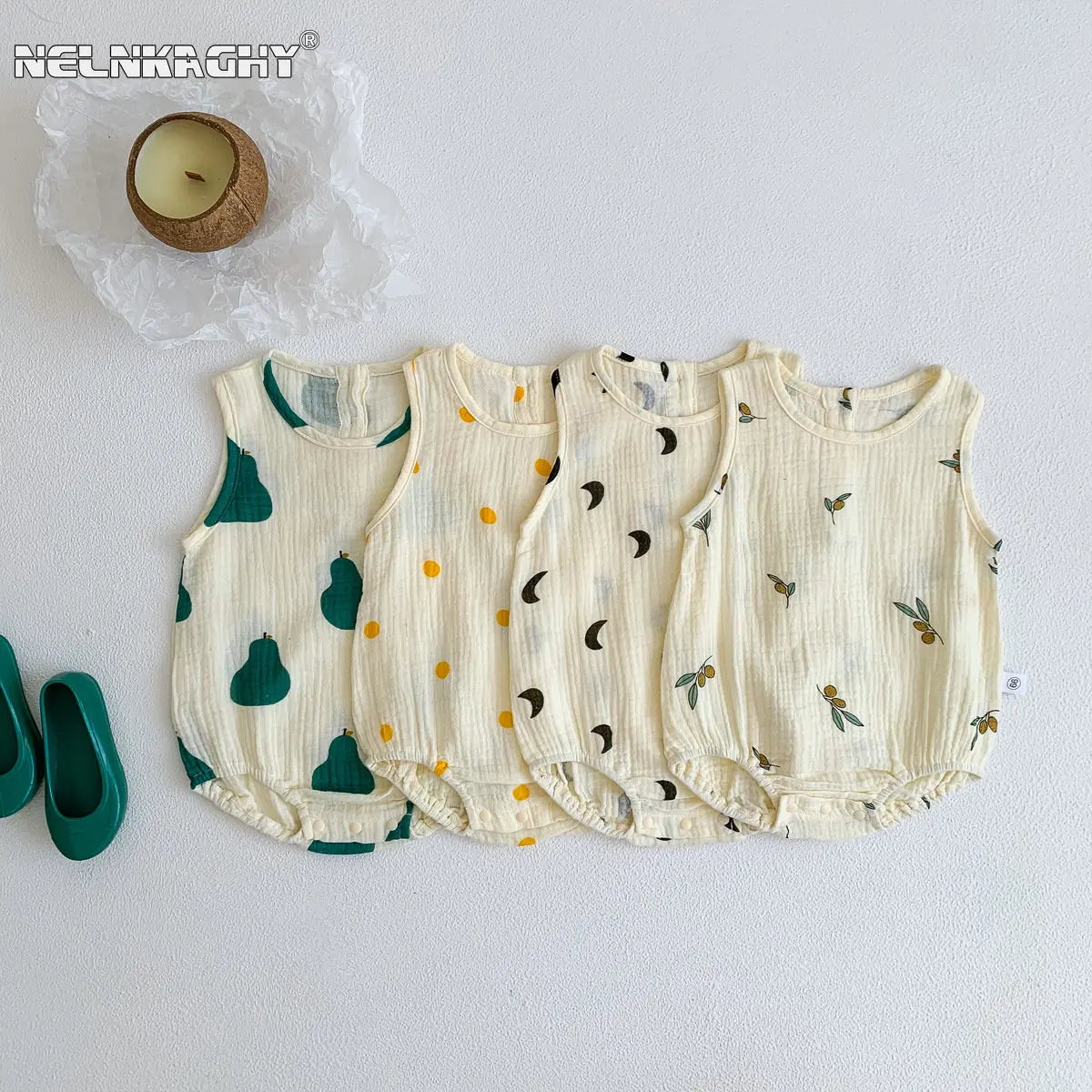 A set of five cream-colored baby cotton sleeveless jumpsuits or bodysuits with subtle green and black leaf patterns.