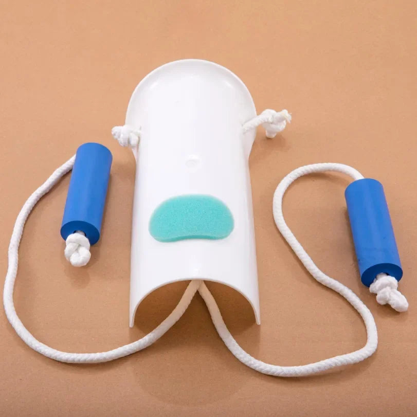 A white sock aid device with blue and green accents is shown on a brown background.