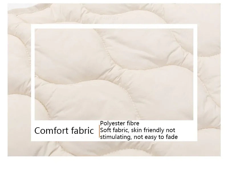 A close-up of a white quilted fabric showing the texture and stitching.