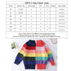 A colorful rainbow striped knit sweater for girls shown flat lay.