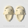 Et par lyse beige sklisandaler med haidesign i EVA, sett ovenfra