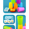 A display of a color-matching cup stacking game featuring various colored plastic cups and challenge cards.