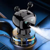 A black rechargeable smart car aroma diffuser is shown emitting a mist onto a blue leather surface.