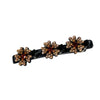 Clip de cabello negro con múltiples grupos de adornos florales dorados y bronce