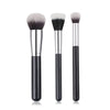 A set of three professional makeup brushes for foundation, concealer, and blush application