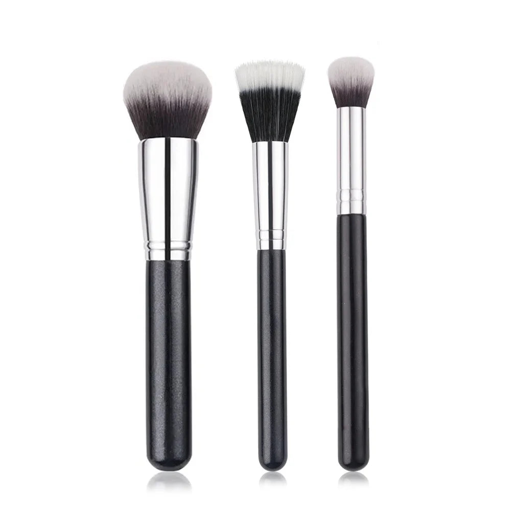 A set of three professional makeup brushes for foundation, concealer, and blush application