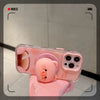 Soporte magnético para teléfono en forma de cerdito rosa sujetado con una mano