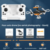 Black four-axis drone with accessories including a protective frame, USB cable, instructions, fan blades, and features like a