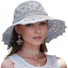 A woman wearing a silver lace-trimmed foldable sun visor hat and necklace.