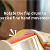 A child's hand is rotating a wooden flip drum to exercise fine hand movements.